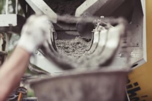 Close-up of concrete being poured from a mixer during a driveway installation in Idaho Falls.