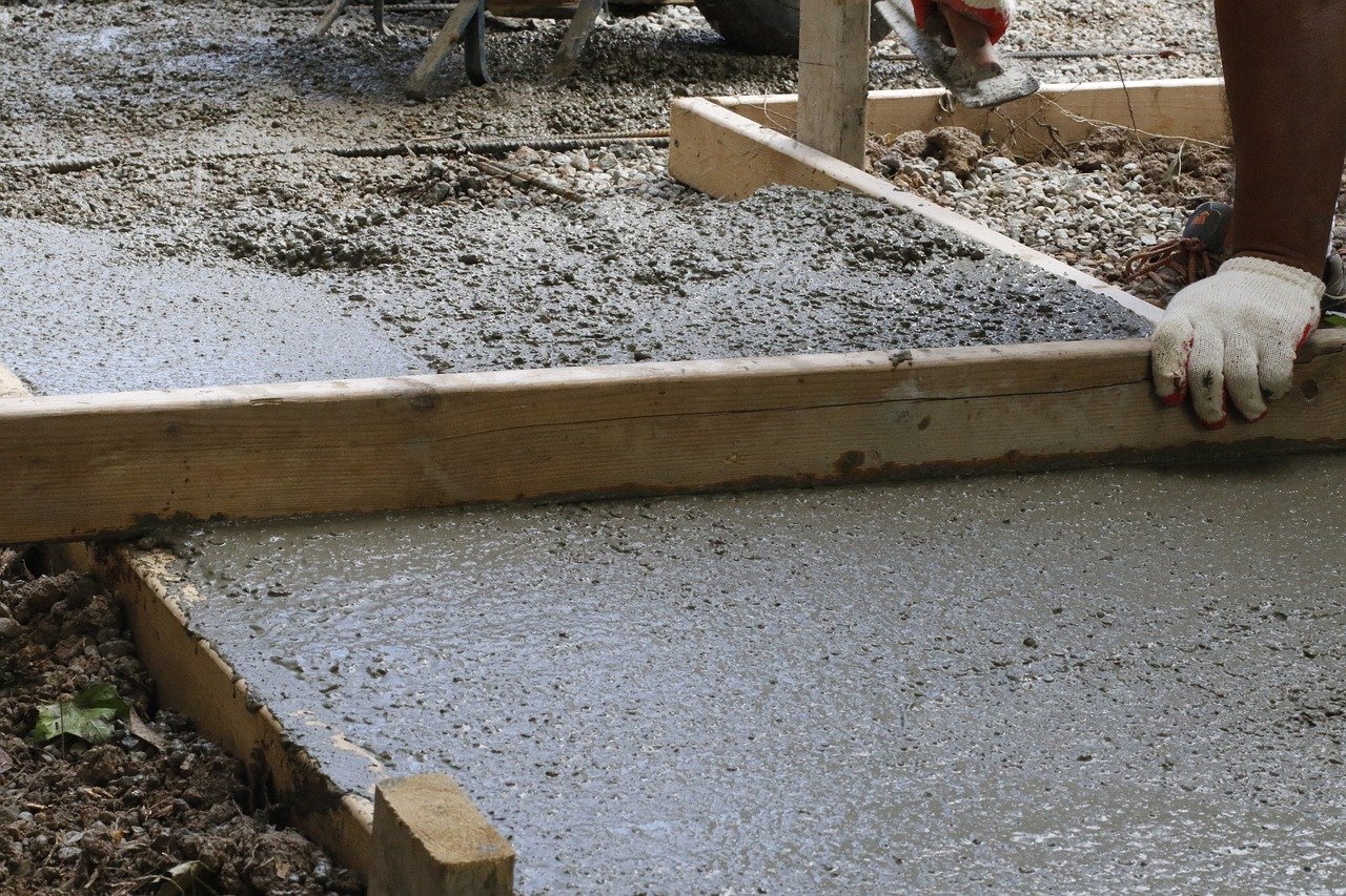 Concrete contractor leveling wet concrete for a residential project in Idaho Falls.